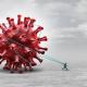 Man pulling large virus with rope
